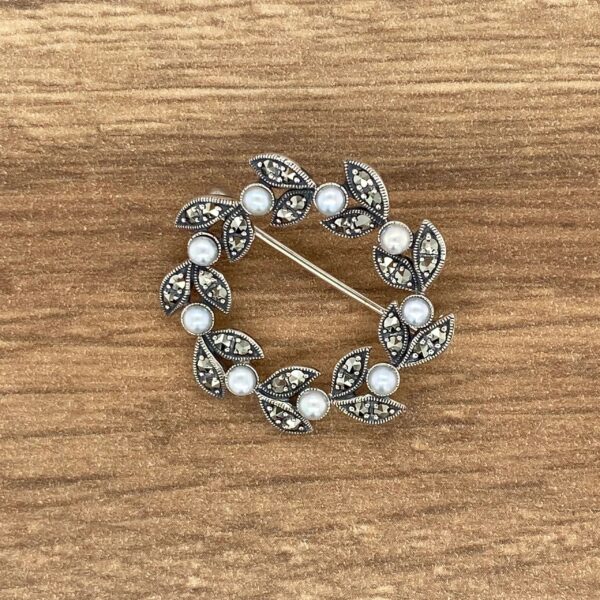 Silver brooch with pearls and marcasite leaves.