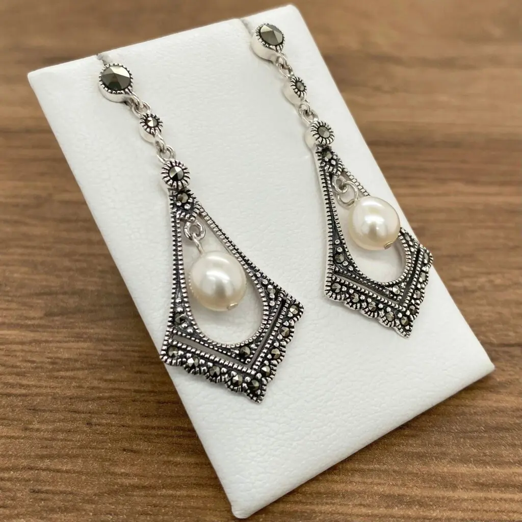 Silver dangle earrings with pearl and marcasite.