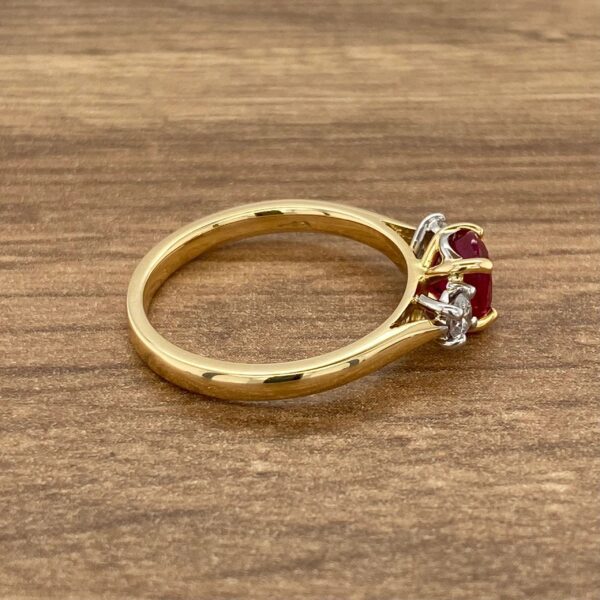 Gold ring with ruby and diamond accents.