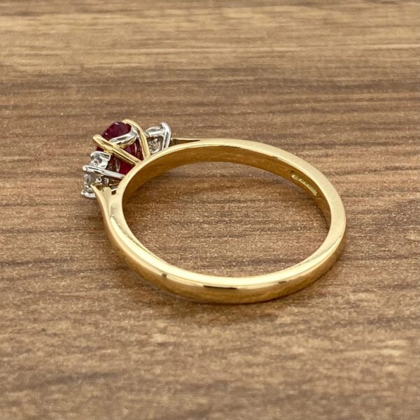 Gold ring with a ruby and diamonds.