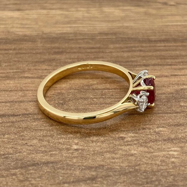 Gold ring with ruby and diamond accents.