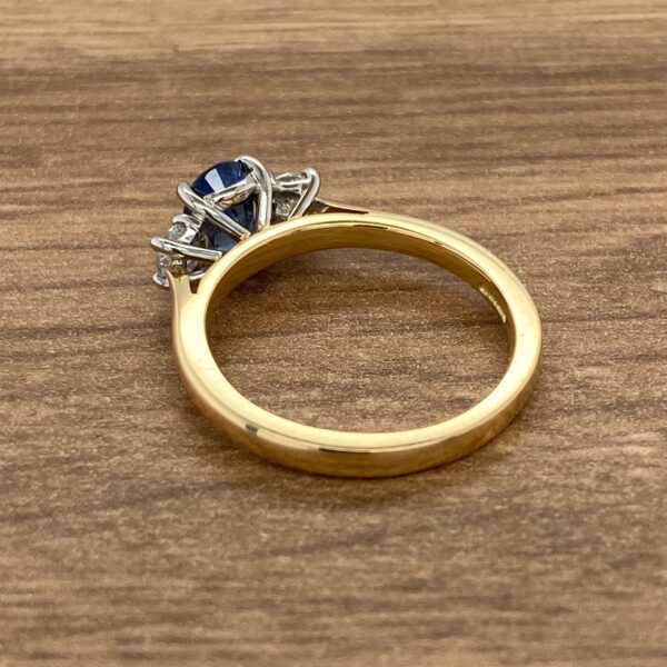 Gold ring with blue sapphire and diamonds.