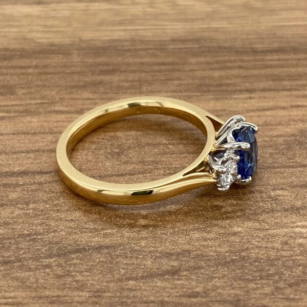 Gold ring with blue sapphire and diamonds.