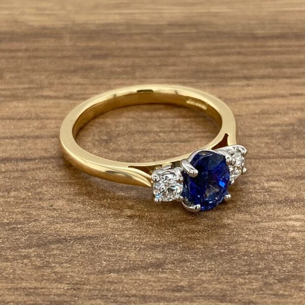 Gold ring with a blue sapphire and diamonds.