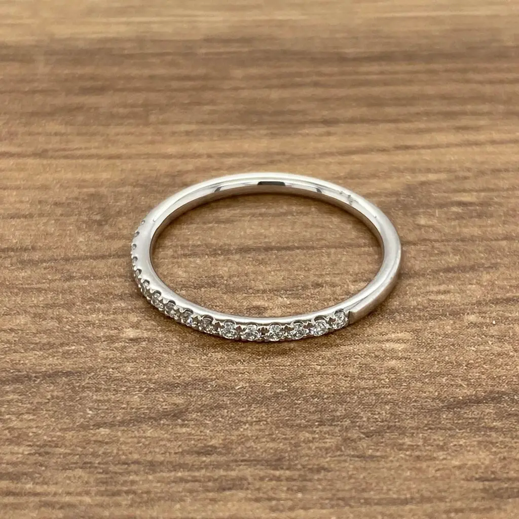 Diamond eternity band on wooden surface.