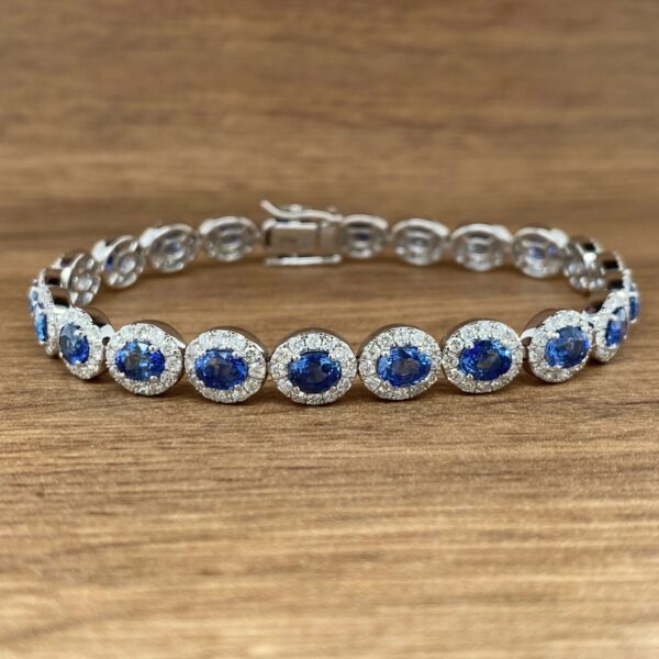 A blue sapphire and diamond bracelet on a wooden table.