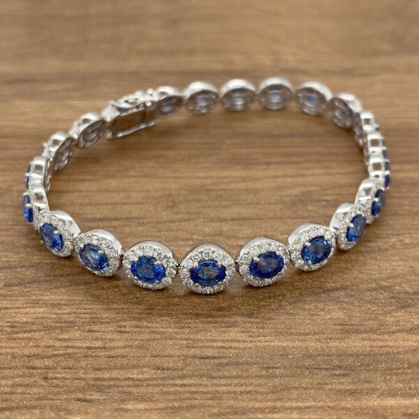 A blue sapphire and diamond bracelet on a wooden table.