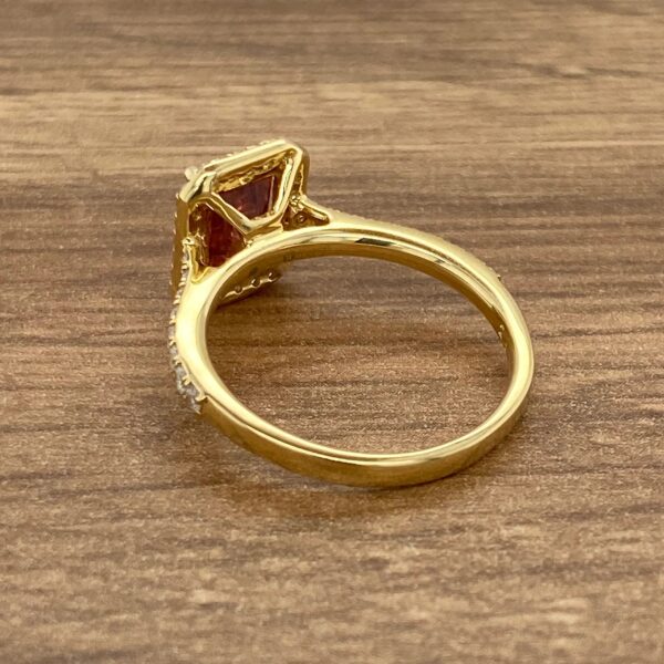 Gold ring with a red gemstone.