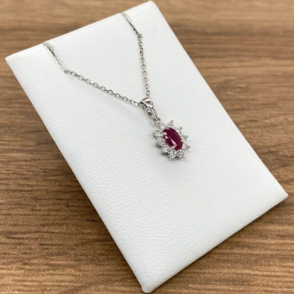 Silver chain with ruby and diamond pendant.