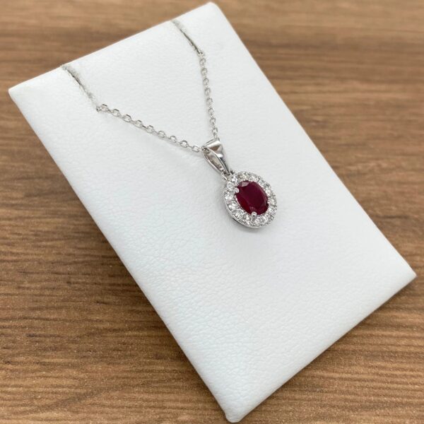 Ruby and diamond pendant necklace on display.