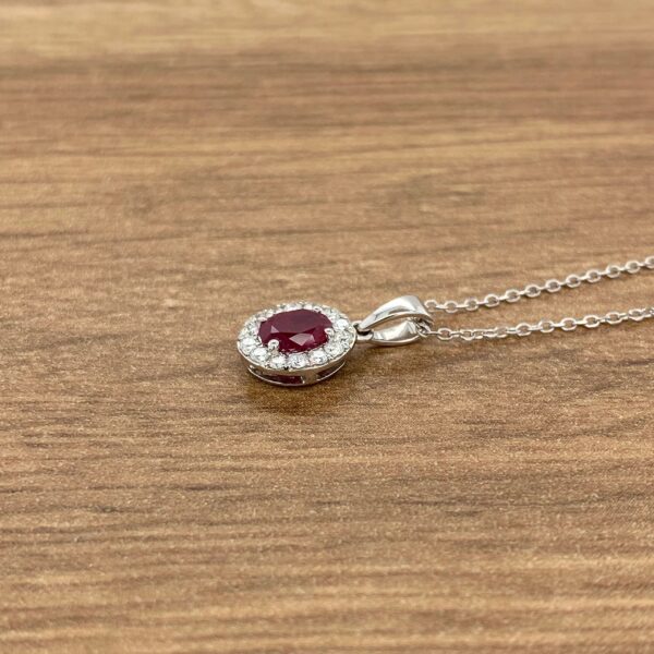 Silver necklace with ruby and diamond pendant.