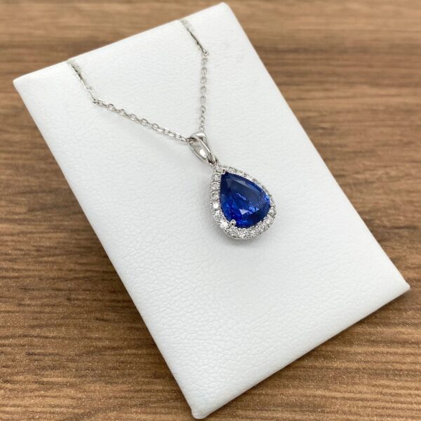 Pear-shaped sapphire pendant with diamond halo.