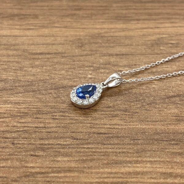 Silver necklace with a blue pear-shaped sapphire.