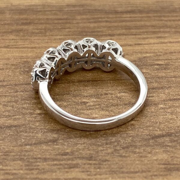 Diamond ring with five stones on band.