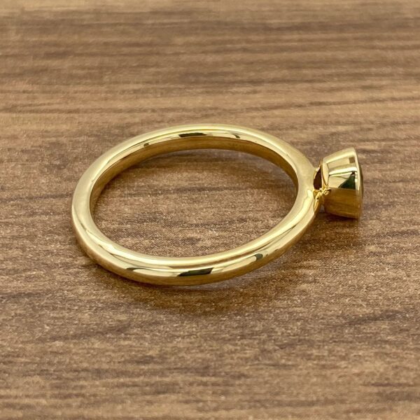 Gold ring with a single gemstone.