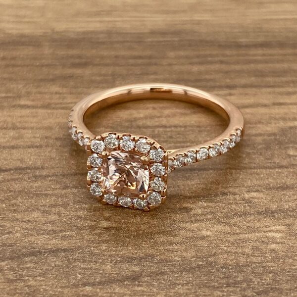 Rose gold ring with a halo setting.