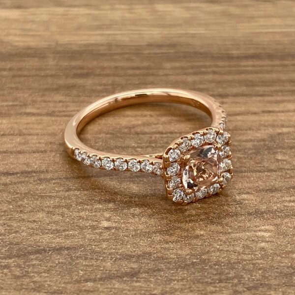 Rose gold engagement ring with a halo setting.