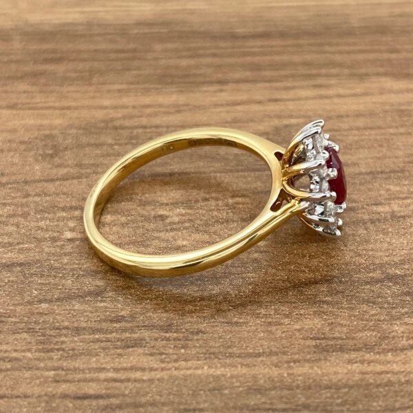 Gold ring with red ruby and diamonds.