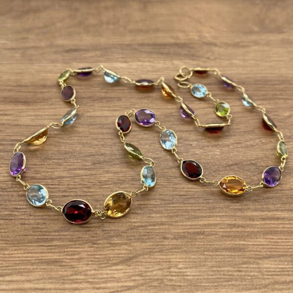 Gold chain with multi-colored gemstones.