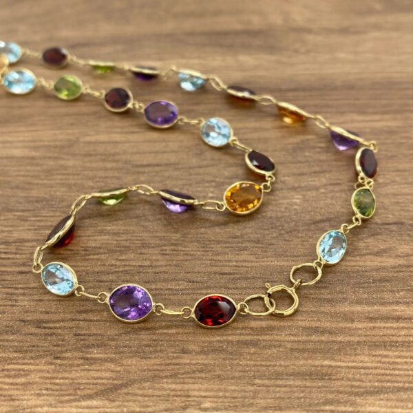 Gold chain with colorful gemstone beads.