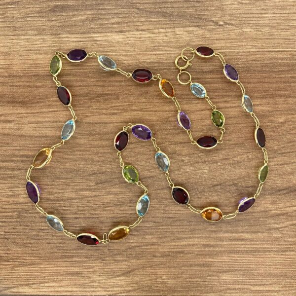 Gold chain with colorful gemstone links.