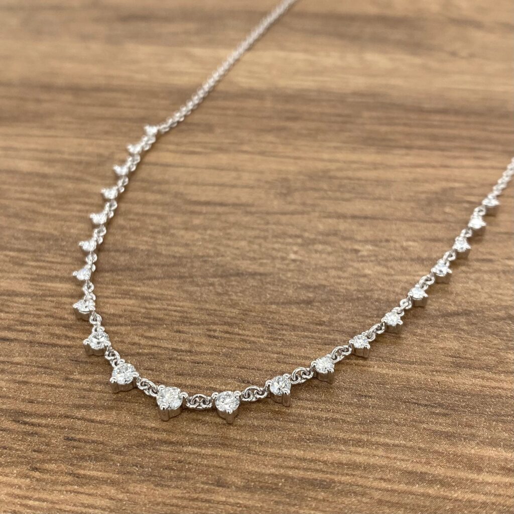 Diamond necklace on wooden background.