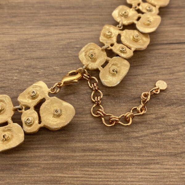 Gold chain necklace with ornate clasp.