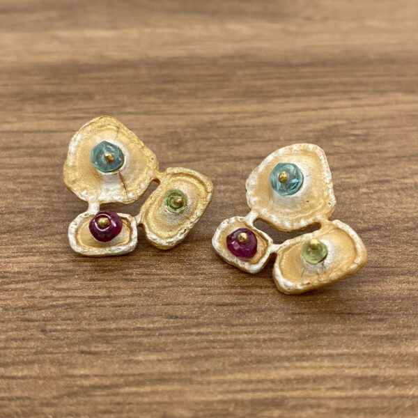 Gold earrings with colorful gemstones.