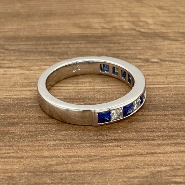 White gold band with blue sapphires.