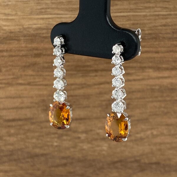 Orange and diamond dangle earrings.