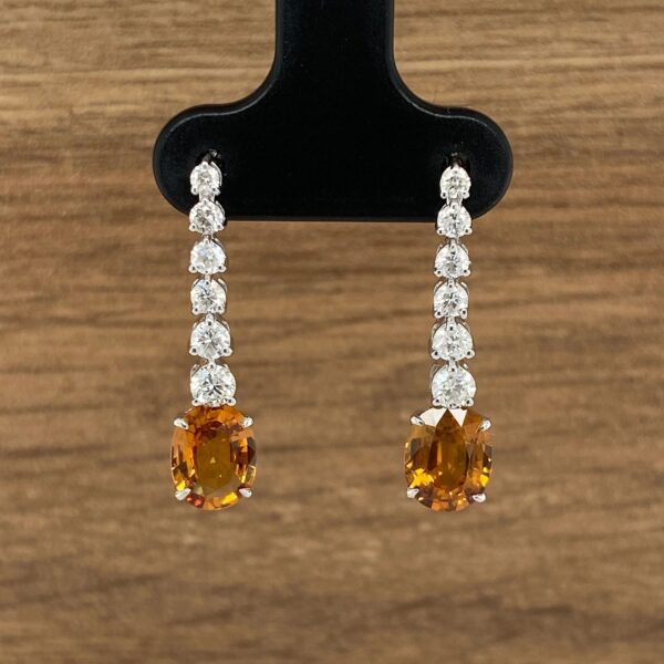 Orange gemstone and diamond earrings.