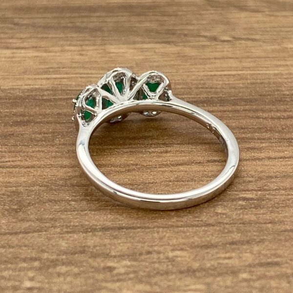 Silver ring with green gemstones.