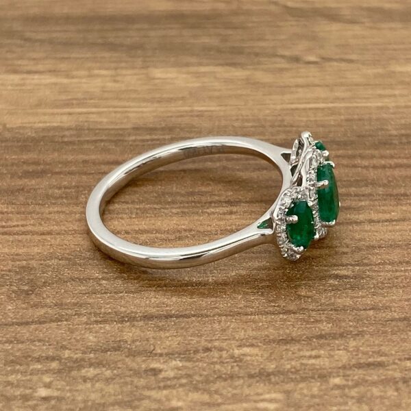 Emerald and diamond three stone ring.