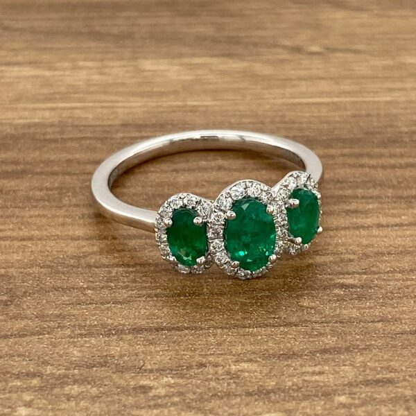 Emerald and diamond three-stone ring.