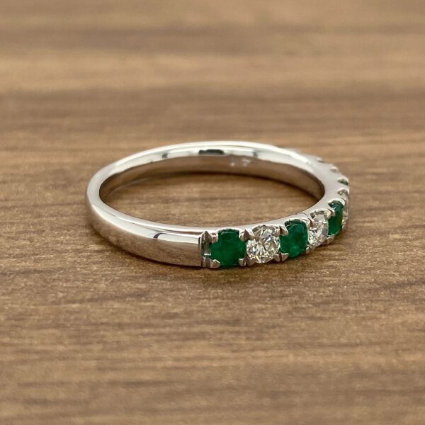 Emerald and diamond eternity band ring.