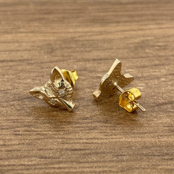 Gold fox head stud earrings with diamonds.