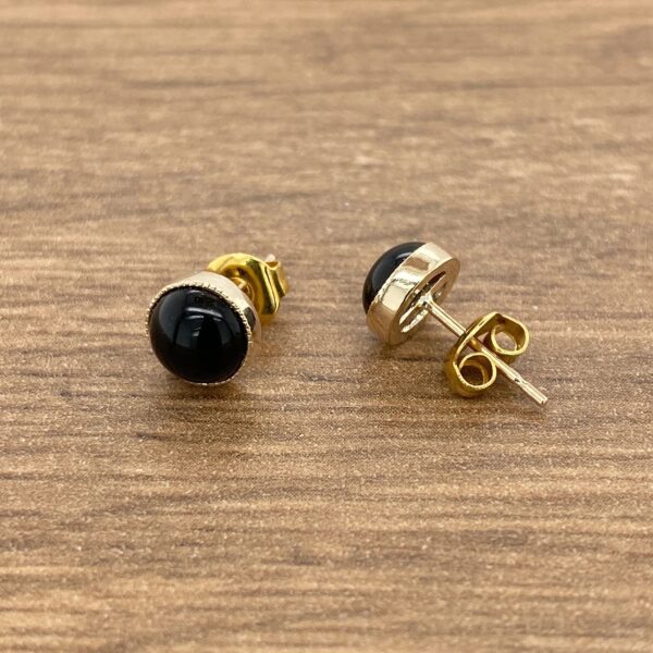 Gold and black gemstone earrings.