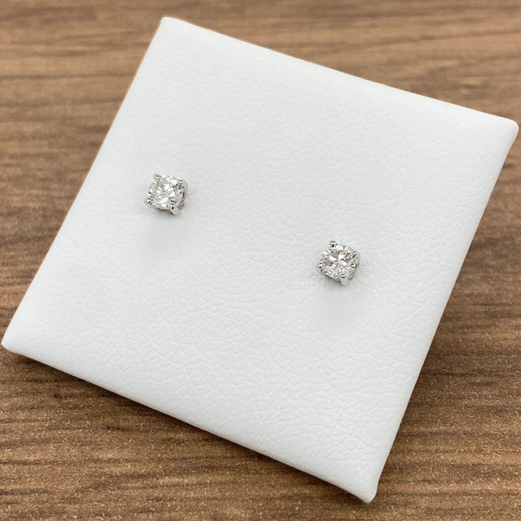 Pair of round diamond stud earrings.