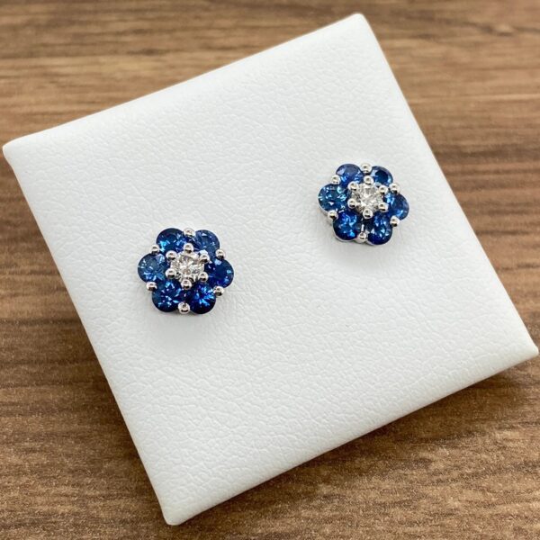 Blue sapphire and diamond flower earrings.