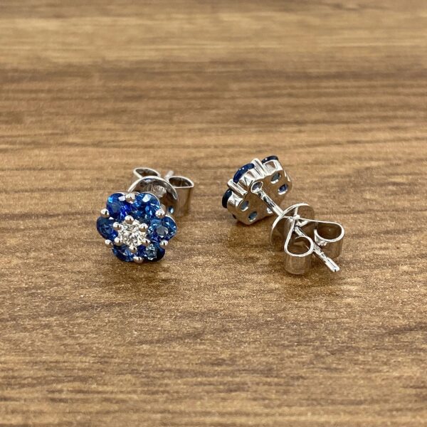 Blue sapphire and diamond flower earrings.