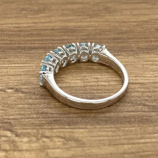 White gold ring with blue gemstones.