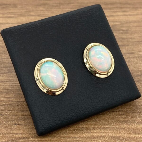 Pair of opal and gold earrings.