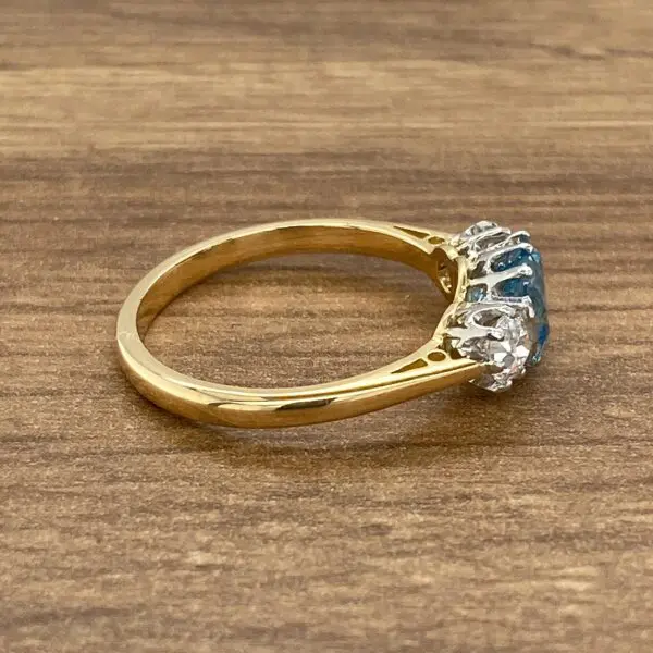 Gold ring with blue and white stones.