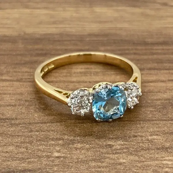 Gold ring with blue and white stones.