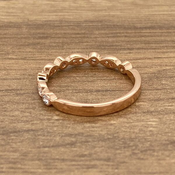 Rose gold band with small diamonds.