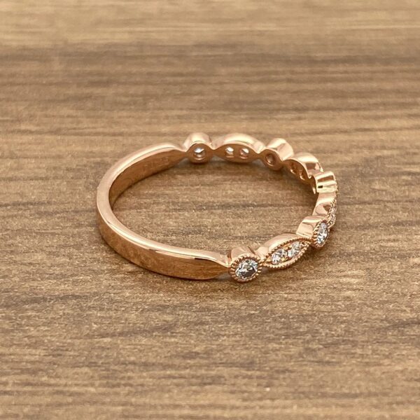 Rose gold band with diamond accents.