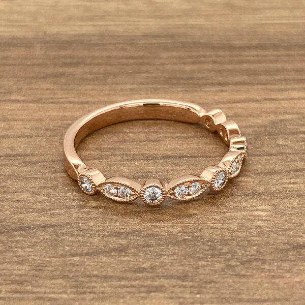 Rose gold band with diamond accents.