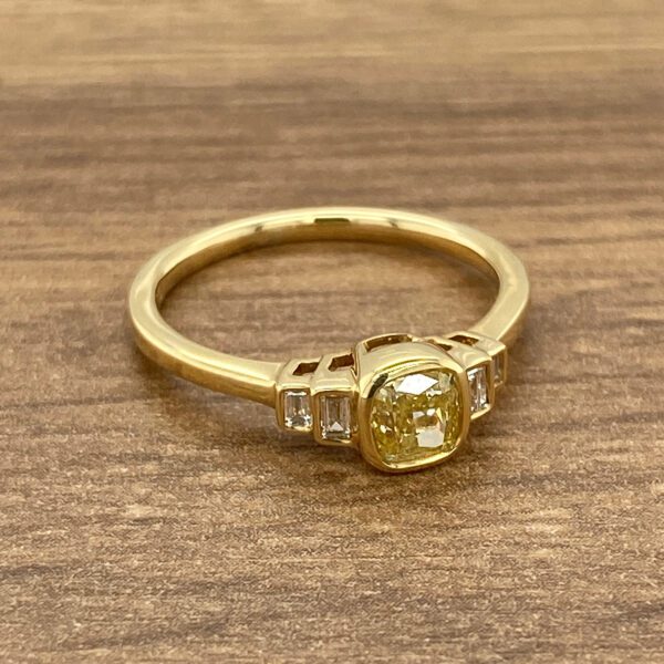 Gold ring with a yellow diamond.