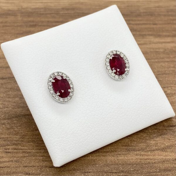 Ruby and diamond halo earrings.