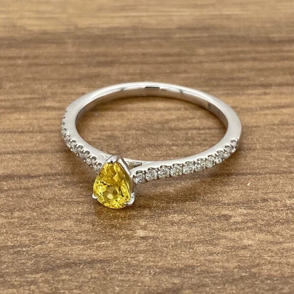 Pear-shaped yellow sapphire engagement ring.